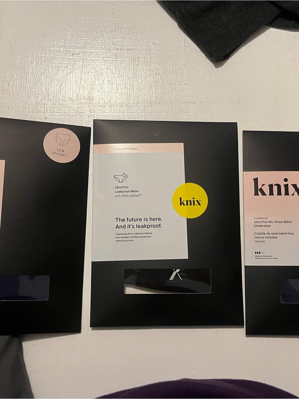 knix Leakproof Bikini Underwear - Black Packaging with Yellow Accent